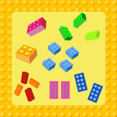 Erivärisiä ja -muotoisia legopalikoita keltaisella taustalla.