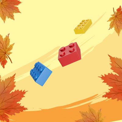 Kuvassa syksyn lehtiä ja legopalikoita.